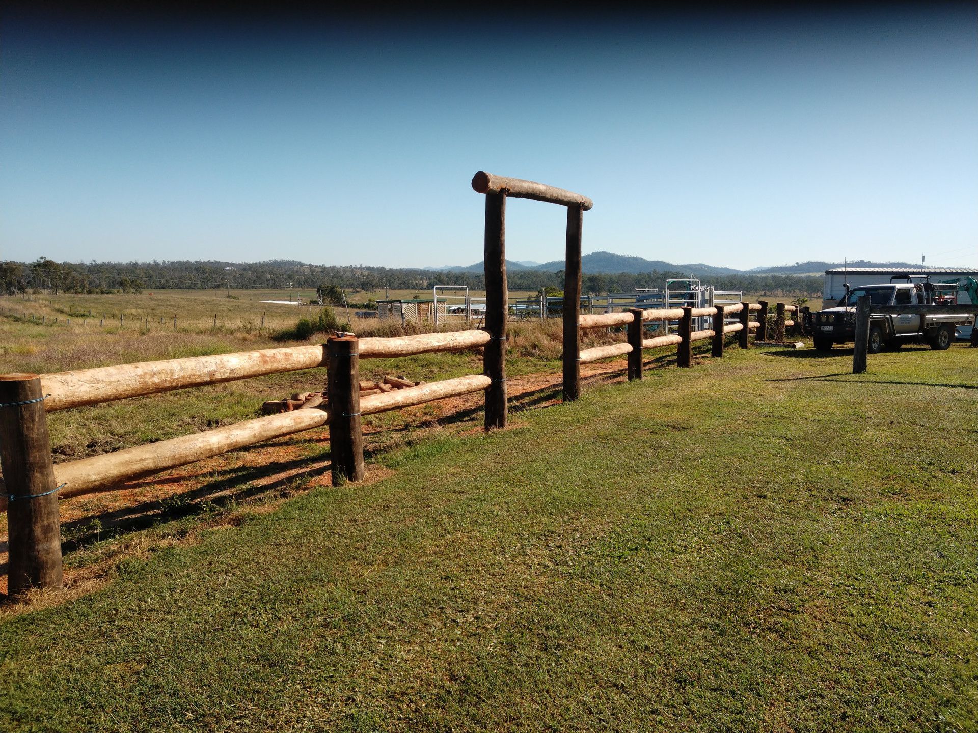 An Excavator Is Digging A Hole In The Ground In The Woods — Mini Excavator Hire & Rural Fencing In Bungundarra, QLD