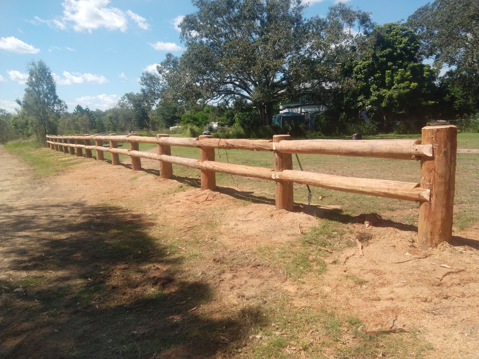 A Wooden Fence Around Property — Mini Excavator Hire & Rural Fencing In Bungundarra, QLD