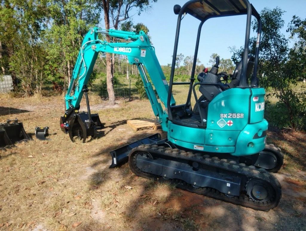 Blue Excavator on Grass Patch — Mini Excavator Hire & Rural Fencing In Bungundarra, QLD