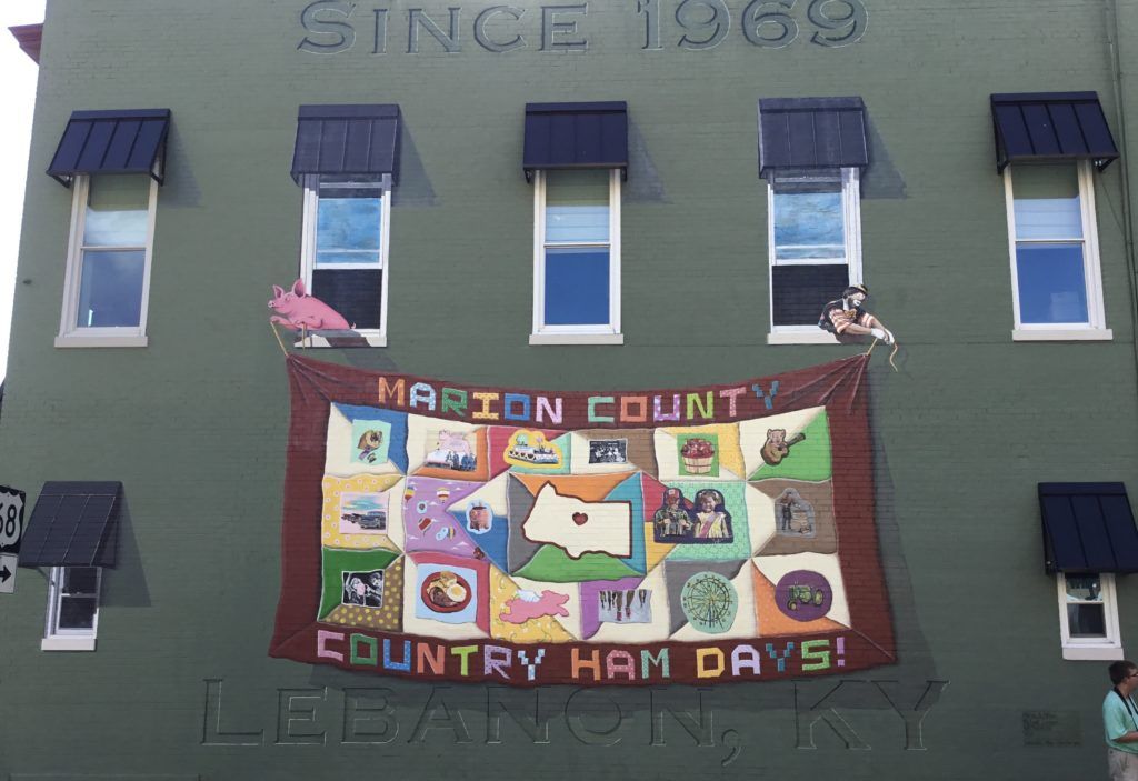 A green building with a banner on the side that says harrison county country ham days