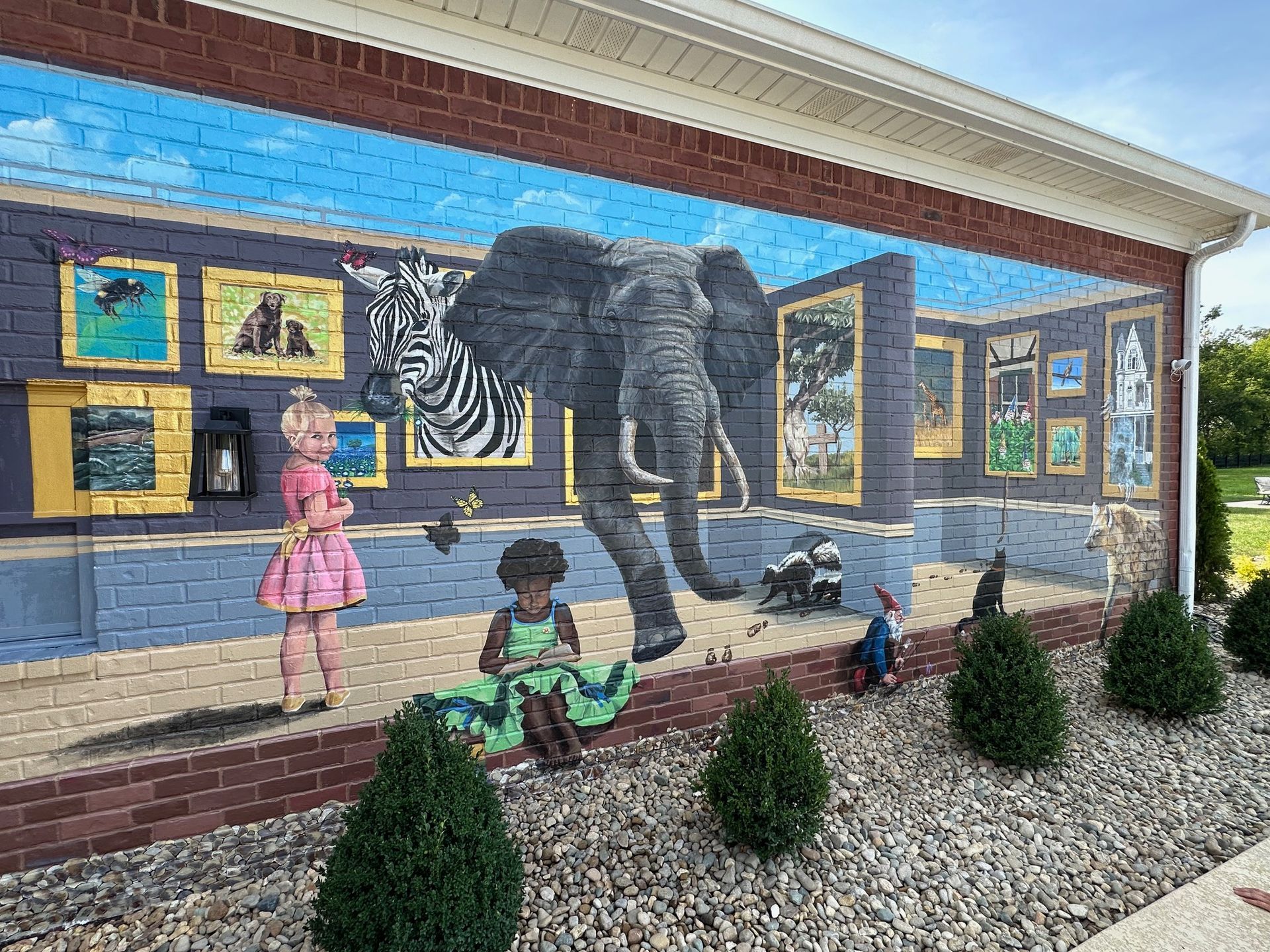 Right Side Focus of Painting Characters in Her Books Painted on This Exterior Brick Wall - Exterior and Residential Mural Art