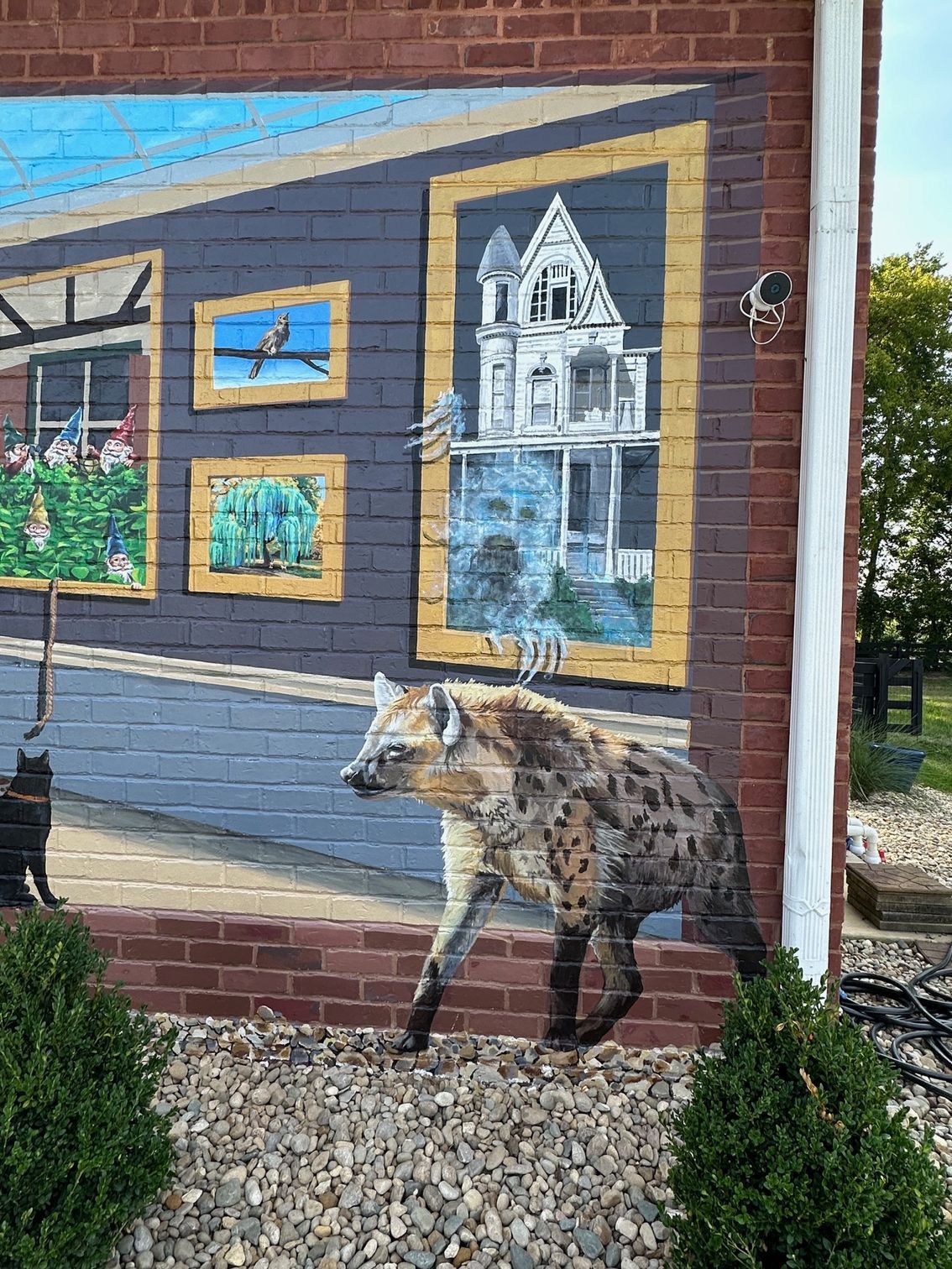House With Ghost and Hyena of Painting Characters in Her Books Painted on This Exterior Brick Wall - Exterior and Residential Mural Art