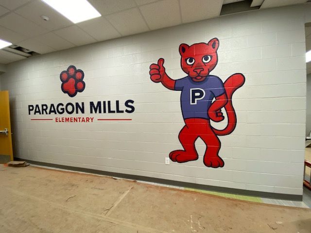 Wall mural at Paragon Mills Elementary: Red panther mascot giving a thumbs-up, school logo with paw print.
