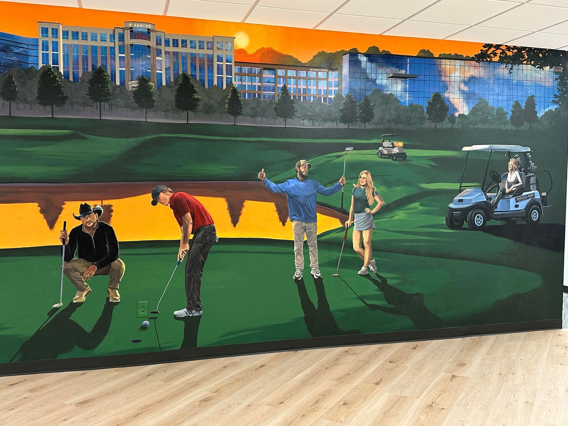 Mural of golf course scene with people playing golf, setting is outdoors with buildings in the background.