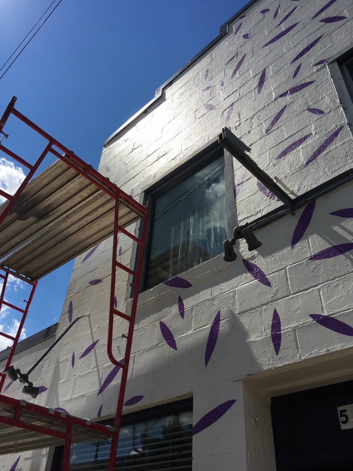 Mural Artist Paints Exterior Wall at Thistle Farms in Nashville TN