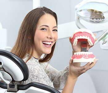 Dentist Patient Smiling with a Plastic Denture — Partial Denture in Westlake, OH