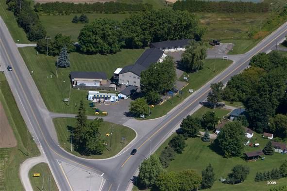 An aerial view of an intersection with a house in the middle