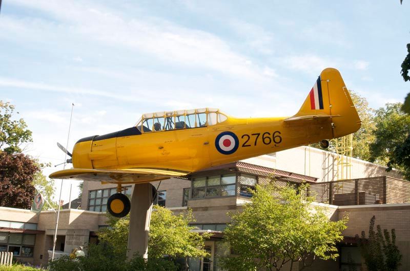 A yellow airplane with the number 2764 on it