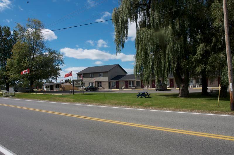 A motel with a canadian flag in front of it