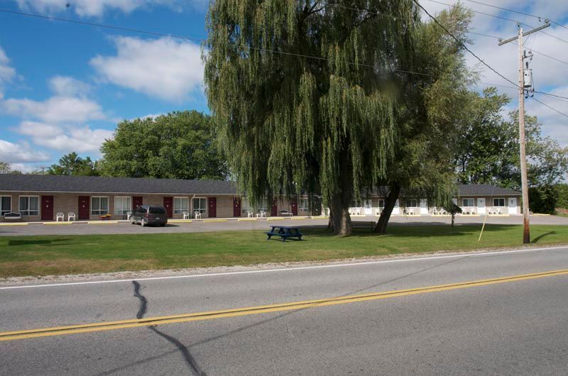 A motel with a picnic table in front of it