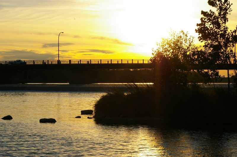 A bridge over a body of water at sunset