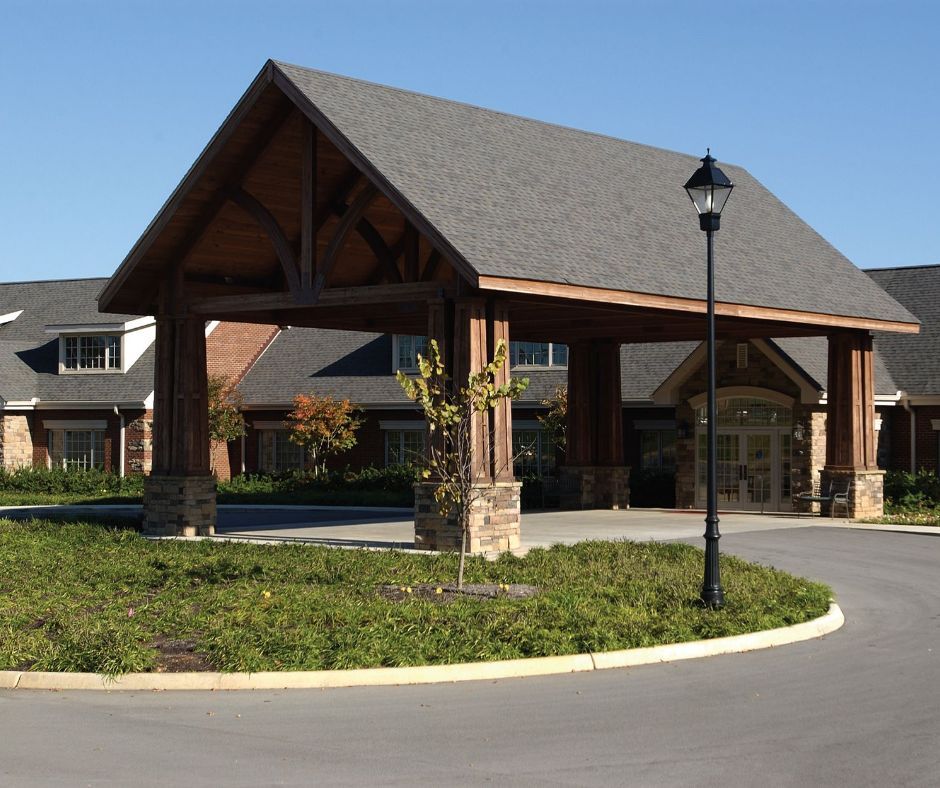 A large building with a covered entrance and a street light