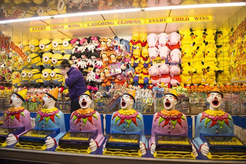A man is standing in front of a carnival game.