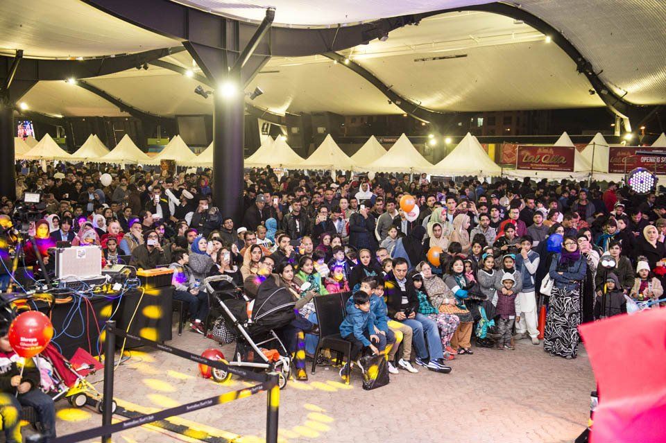 A large crowd of people are gathered in a large room.