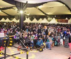 A large crowd of people are gathered in a large room.