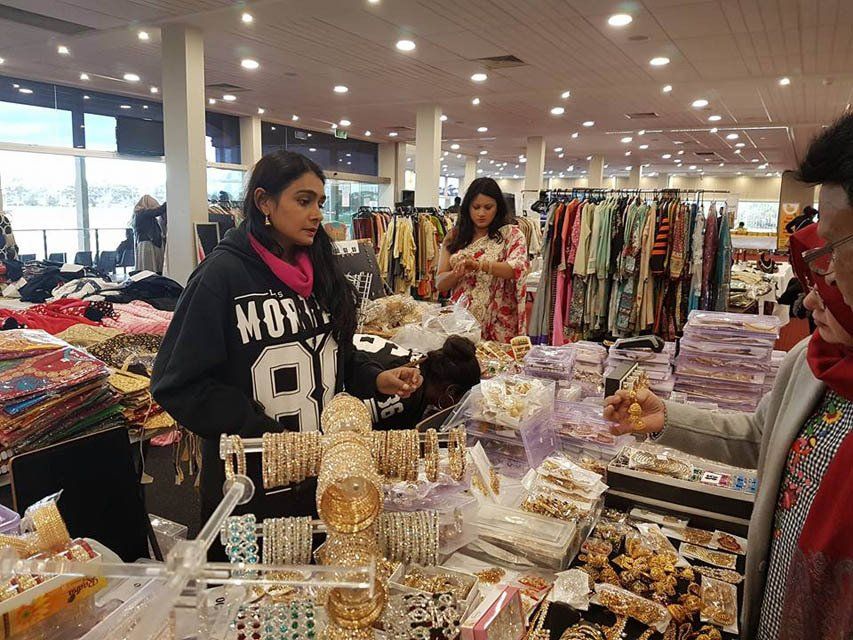 A group of people are shopping in a store.