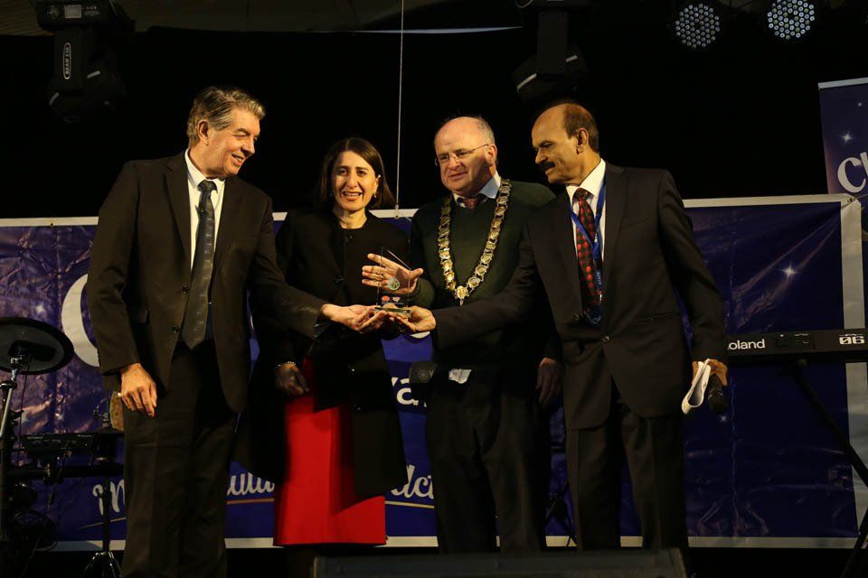 A man in a suit and tie is shaking hands with a woman