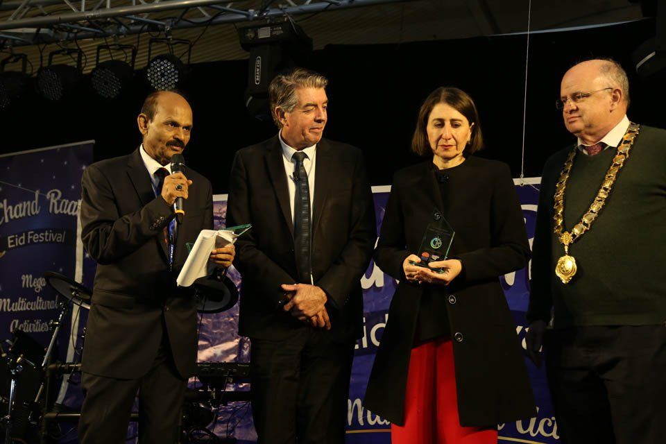 A group of people standing in front of a sign that says thank you