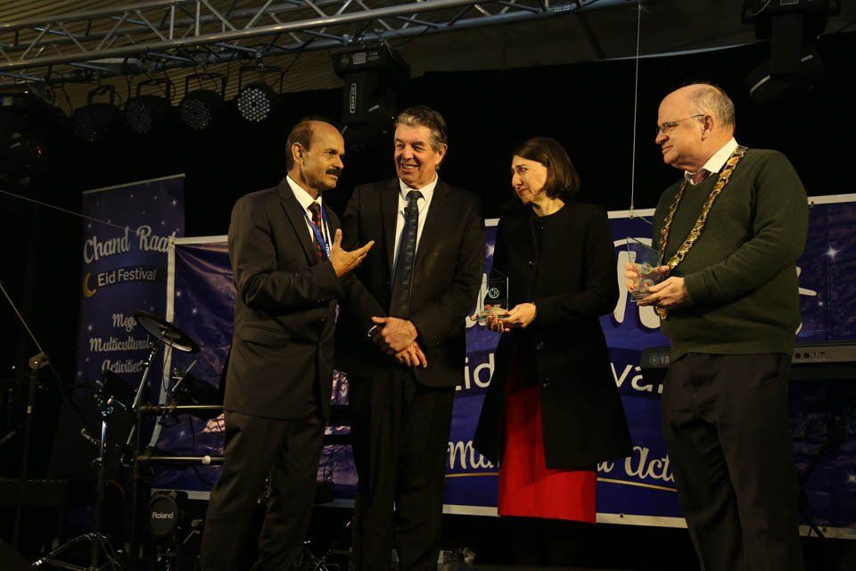 A group of people standing in front of a sign that says thank you