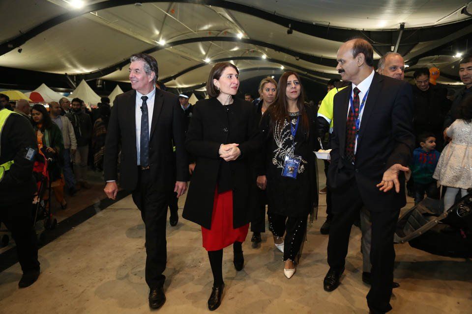 A group of people are walking in a room.