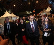 A group of people are standing in a room with tents.