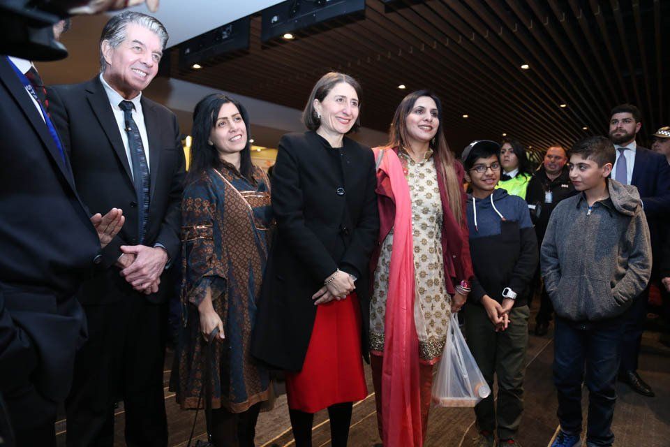 A group of people standing next to each other in a room.