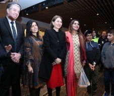 A group of people standing next to each other in a room.