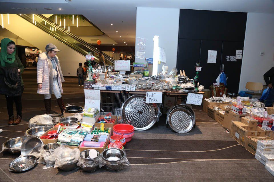 A table full of pots and pans with a sign that says ' no pets ' on it