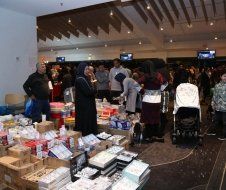 A group of people are standing around a table in a room.