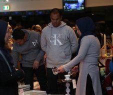 A group of people are standing around a table in a room.