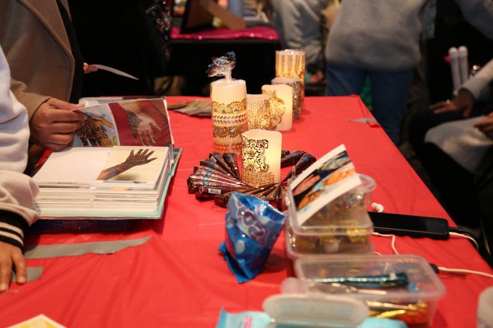 A table with a lot of items on it including candles