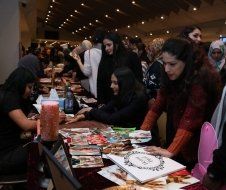 A group of women are sitting at a table in a room.