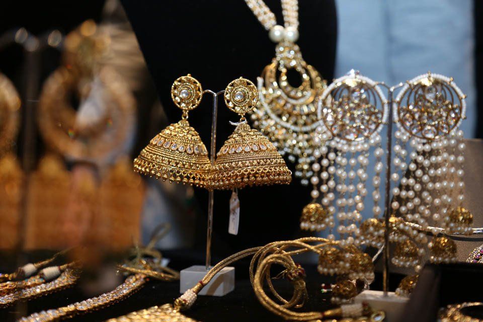A display of gold and pearl jewelry on a table