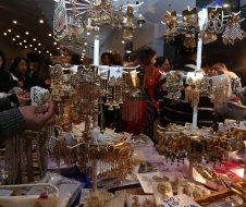 A group of people are standing around a table in a store.