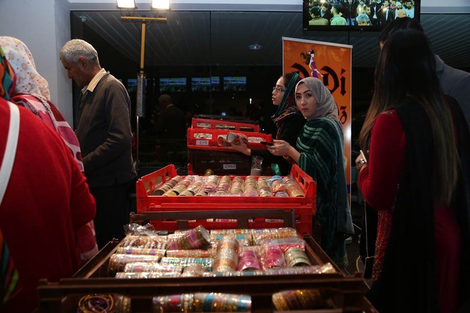 A group of people are standing around a display of food.