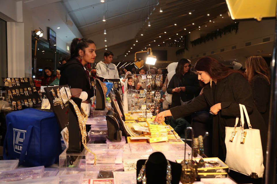 A group of people are shopping at a jewelry store.
