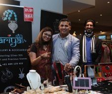 A group of people are posing for a picture in front of a jewelry store.