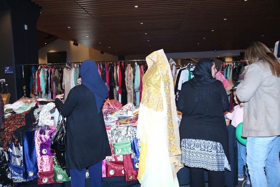 A group of women are looking at clothes in a store