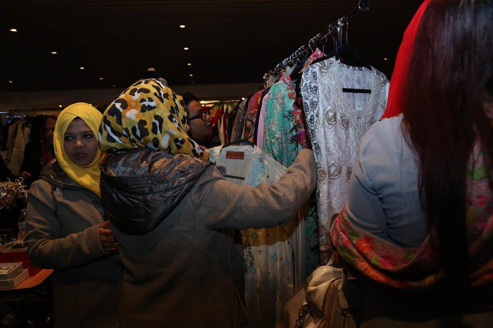 A group of women are looking at clothes in a store