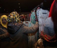 A group of women are shopping for clothes in a store.