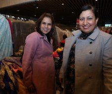 Two women are posing for a picture in a store.