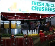 A juice stand with a sign that says fresh juice crushers