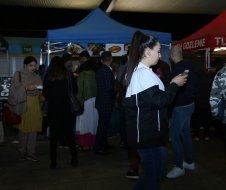 A group of people are standing in front of a tent.