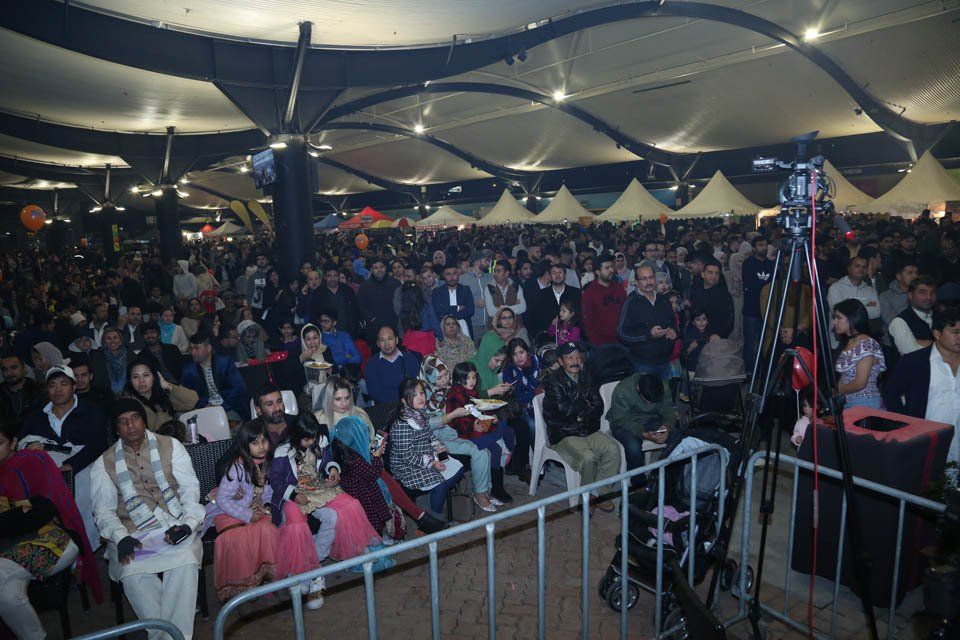 A large crowd of people are sitting in a large room.