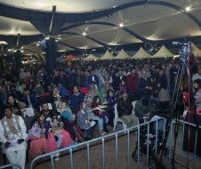 A large crowd of people are sitting in a large room.