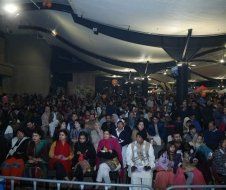 A large group of people are sitting in a large room.