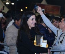 A man is taking a picture of a woman with a camera.