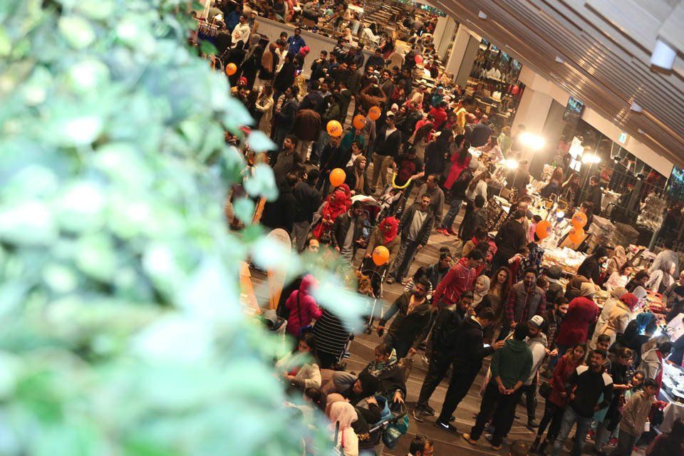 A large crowd of people are gathered in a building.