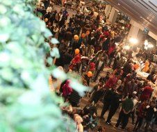 A large group of people are standing in a room.