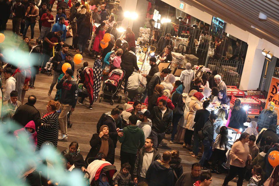 A large group of people are gathered in a large room.